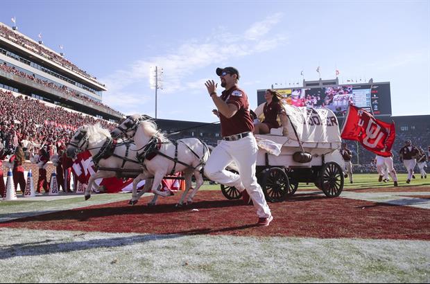 Dude Gets Dragged Off Field Behind Oklahoma's traditional Sooner Schooner's Wagon During TD Celebrat